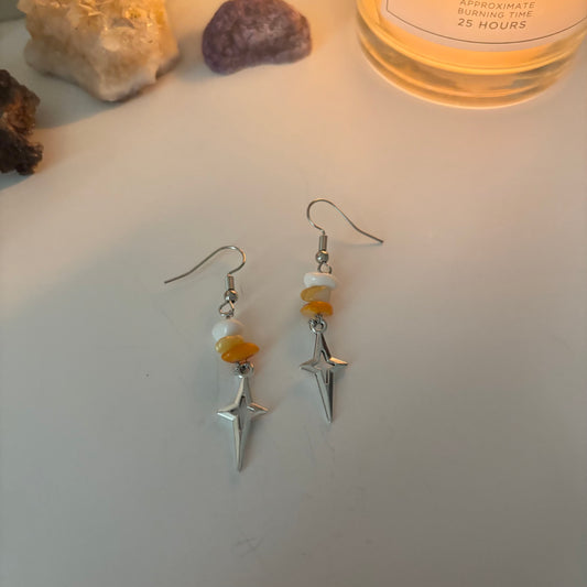 orange star dangly earrings